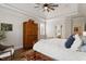 Spacious main bedroom with hardwood floors, neutral walls, and white bedding accents the beautiful architecture at 907 Vintage Hill Pkwy, Durham, NC 27712