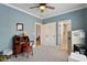 Spacious office space with gray carpet, a wooden desk, and views into the bathroom at 907 Vintage Hill Pkwy, Durham, NC 27712