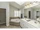 Bright bathroom featuring a soaking tub, double vanity, and tiled flooring at 9244 Palm Bay Cir, Raleigh, NC 27617