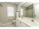 Well-lit bathroom with a double sink vanity and a separate shower area at 9244 Palm Bay Cir, Raleigh, NC 27617