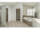 Serene bathroom with soaking tub, tiled floors, and a glass-enclosed shower at 9244 Palm Bay Cir, Raleigh, NC 27617