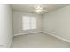 A neutral carpeted room with a ceiling fan and window at 9244 Palm Bay Cir, Raleigh, NC 27617