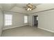 Large bedroom with neutral carpeting, ceiling fan and plenty of natural light at 9244 Palm Bay Cir, Raleigh, NC 27617