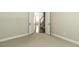 Bedroom with carpet and double doors to view the wooden staircase in the hall at 9244 Palm Bay Cir, Raleigh, NC 27617