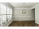 Well-lit dining room featuring hardwood floors, molding, and bright windows at 9244 Palm Bay Cir, Raleigh, NC 27617