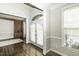 Inviting entryway featuring hardwood floors, arched windows, and custom built-in shelving, adding character to the home at 9244 Palm Bay Cir, Raleigh, NC 27617