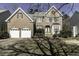 Charming brick home featuring an attached two-car garage and manicured landscaping at 9244 Palm Bay Cir, Raleigh, NC 27617