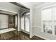 Bright foyer with hardwood floors, white trim and adjacent room with a bookshelf at 9244 Palm Bay Cir, Raleigh, NC 27617