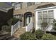 Brick home entrance with arched doorway and meticulous landscaping at 9244 Palm Bay Cir, Raleigh, NC 27617