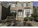 Brick home entrance featuring elegant stairs and manicured landscaping at 9244 Palm Bay Cir, Raleigh, NC 27617