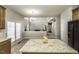 Spacious kitchen with granite countertops, stainless steel appliances, and view to living room with fireplace and many windows at 9244 Palm Bay Cir, Raleigh, NC 27617