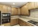 Bright kitchen with stainless steel appliances, granite countertops, and tiled backsplash, creating a chef's dream at 9244 Palm Bay Cir, Raleigh, NC 27617