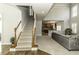 Living room with staircase and kitchen in view, perfect for entertaining and modern living at 9244 Palm Bay Cir, Raleigh, NC 27617