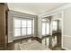 Bright living room with hardwood floors, white trim and large windows at 9244 Palm Bay Cir, Raleigh, NC 27617