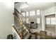 Staircase leading to a living room with fireplace and many windows, creating a bright and inviting atmosphere at 9244 Palm Bay Cir, Raleigh, NC 27617
