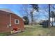 The backyard with red brick wall and a shed at 103 W Thorndale Dr, Oxford, NC 27565