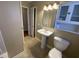 Bathroom with pedestal sink, toilet, vanity lighting and mirror at 103 W Thorndale Dr, Oxford, NC 27565