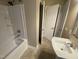 Bright bathroom features tub/shower combo, toilet, and vanity with white fixtures at 103 W Thorndale Dr, Oxford, NC 27565