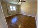 Bright bedroom featuring hardwood floors, neutral walls, and a window with light-colored curtains at 103 W Thorndale Dr, Oxford, NC 27565
