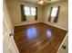 Bedroom with wood floor, neutral walls, ceiling fan, and two windows with gray curtains at 103 W Thorndale Dr, Oxford, NC 27565