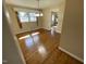 Hardwood floors in dining area with modern lighting fixture and an adjacent laundry room at 103 W Thorndale Dr, Oxford, NC 27565