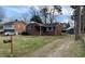 Charming brick home with well-maintained lawn and an inviting driveway at 103 W Thorndale Dr, Oxford, NC 27565
