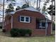 View of a charming brick home with dark shutters and a covered porch in the front at 103 W Thorndale Dr, Oxford, NC 27565