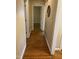 Hallway with hardwood floors, neutral paint, and white trim leading to other rooms at 103 W Thorndale Dr, Oxford, NC 27565