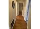 Hallway with hardwood floors leading to multiple rooms at 103 W Thorndale Dr, Oxford, NC 27565