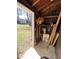 Open view of the interior of a wooden shed, storage space, and door to the yard at 103 W Thorndale Dr, Oxford, NC 27565