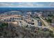 Aerial view of real estate community near wooded area with new homes and some pond views at 1067 Fairhaven Dr # 53, Mebane, NC 27302