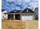New construction features a brick facade, a two-car garage, and a contrasting gray gable at 1067 Fairhaven Dr # 53, Mebane, NC 27302
