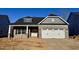 New construction features a brick facade, a two-car garage, and a contrasting gray gable at 1067 Fairhaven Dr # 53, Mebane, NC 27302
