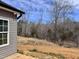 Exterior view of a home showcasing gray siding and an unfinished landscape at 1067 Fairhaven Dr # 53, Mebane, NC 27302