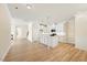 Open kitchen with a center island, white cabinets, and hardwood floors at 1067 Fairhaven Dr # 53, Mebane, NC 27302