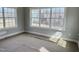 Sunlit living room with large windows, showcasing views of the surrounding landscape at 1067 Fairhaven Dr # 53, Mebane, NC 27302