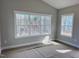 Bright living room featuring expansive windows with trim, offering natural light at 1067 Fairhaven Dr # 53, Mebane, NC 27302