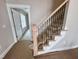 Staircase features stained wood banister with elegant black wrought iron balusters at 1067 Fairhaven Dr # 53, Mebane, NC 27302