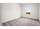 Bright bedroom featuring plush carpeting and a window with neighborhood views at 111 E Victory View Ter, Smithfield, NC 27577