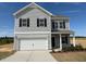 Charming two-story home with a two-car garage, black shutters, and a well-manicured lawn at 111 E Victory View Ter, Smithfield, NC 27577
