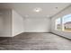 Neutral living room featuring recessed lighting and wood-look flooring with views of the neighborhood from the windows at 111 E Victory View Ter, Smithfield, NC 27577