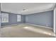 Spacious bedroom with light blue walls, carpet, and natural light from two windows at 113 Bonner Ct, Cary, NC 27511