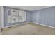 Bright bedroom featuring blue walls, carpet, and a shuttered window that lets in natural light at 113 Bonner Ct, Cary, NC 27511