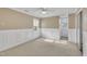 Charming bedroom with wainscoting, neutral walls, carpet and natural light from three windows at 113 Bonner Ct, Cary, NC 27511