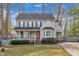 Charming two-story home with a front porch, landscaped yard, and inviting red door at 113 Bonner Ct, Cary, NC 27511