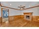 Cozy living room featuring a brick fireplace, ceiling fan and hardwood floors at 113 Bonner Ct, Cary, NC 27511