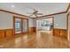 Spacious living room with hardwood floors, wood trim, and access to other rooms at 113 Bonner Ct, Cary, NC 27511