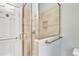 Elegant tiled shower with a glass enclosure, built-in niche, and brass hardware at 113 Bonner Ct, Cary, NC 27511