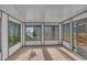 Bright sunroom with large windows offering views of the outdoors and access to the backyard at 113 Bonner Ct, Cary, NC 27511