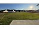 Large grassy backyard, offering ample outdoor space, with view of neighboring homes at 12 Flatland Dr, Princeton, NC 27569